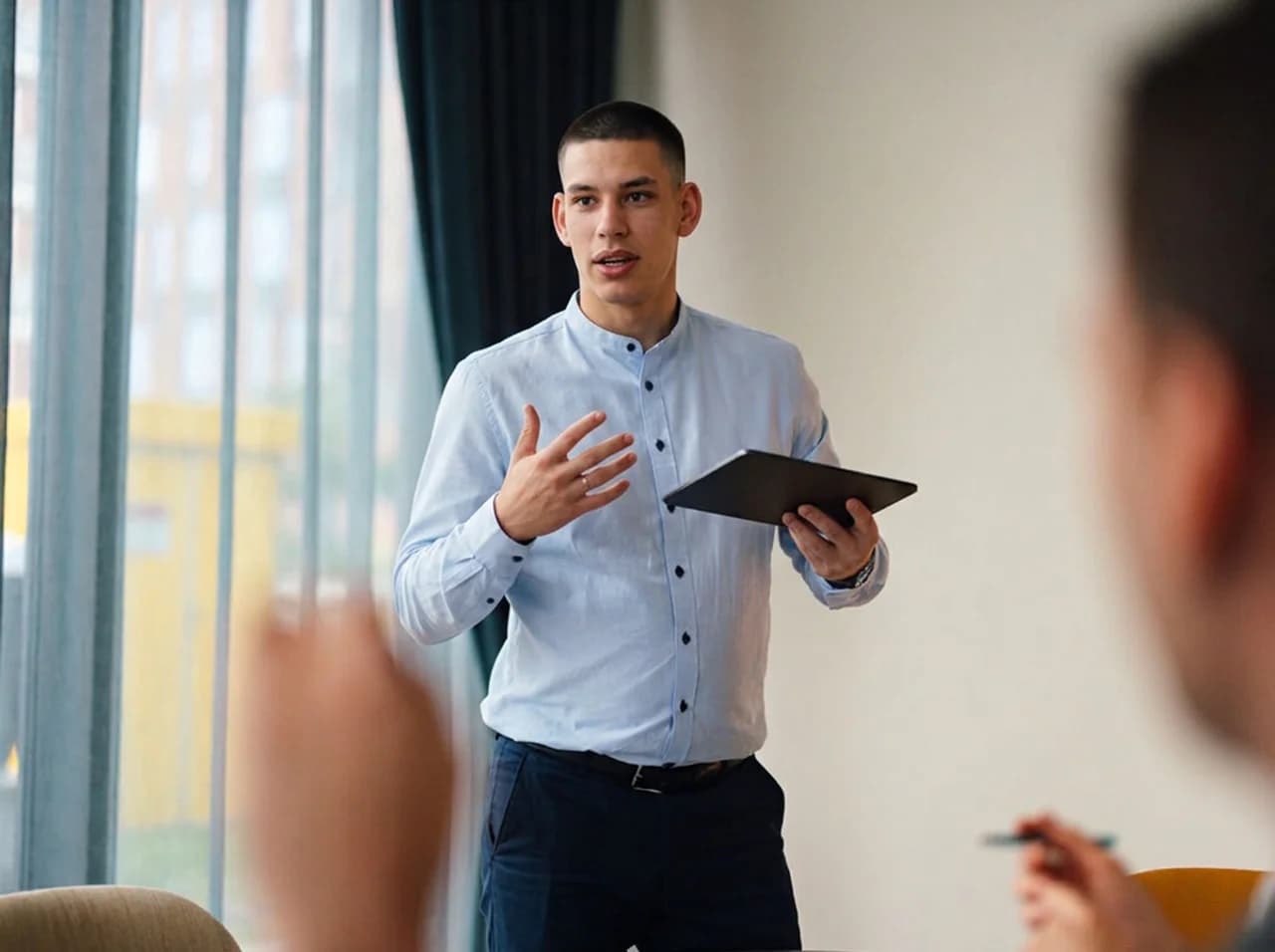 CT1 engineer presenting to colleagues with a tablet